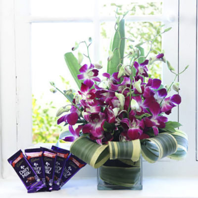 Orchids in a vase and Chocolates