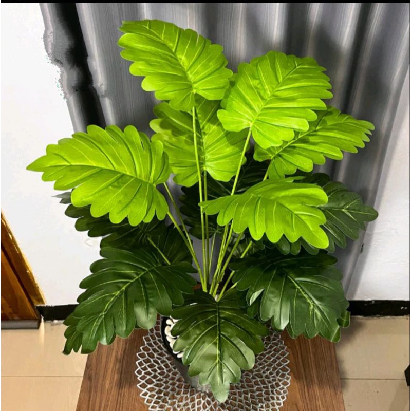 Bring a touch of lush, tropical beauty to any space without the fuss with our Lifelike Artificial Monstera Leaf Tree.